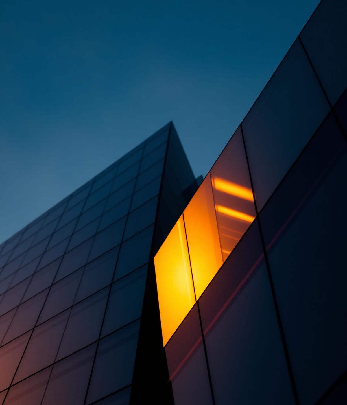 Modern glass tower catching golden light